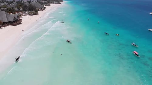Aerial View of Fishing Boats Swaying on the Waves Off a Paradise Beach Zanzibar