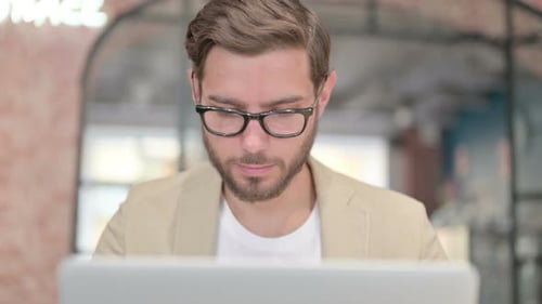 Close Up of Man Working on Laptop