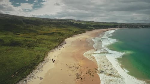 Aerial Coast Beach: Atlantic Ocean, Antrim County, Northern Ireland. People Walking on Sandy Shore