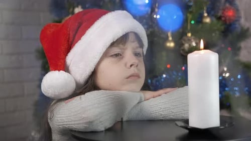 Child Look at Candle in Decorated Room