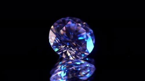 Blue Diamond Rotating on Black Reflective Surface