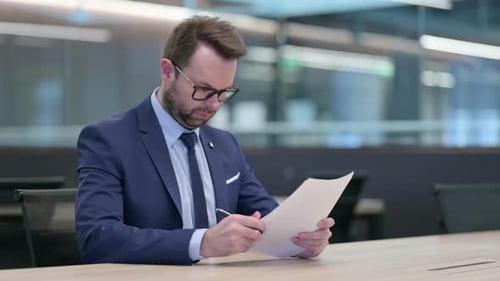 Man Signing Document in Modern Conference Room