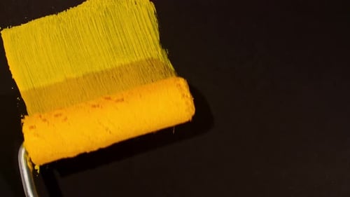 Yellow Paint Roller Applying Vibrant Color