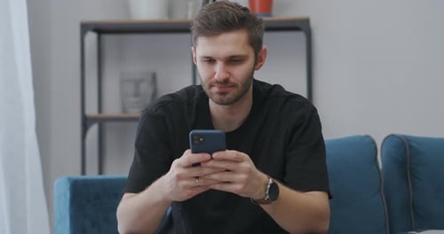 Young Adult Using a Smartphone Indoors