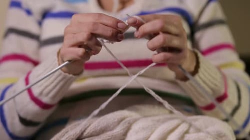 Woman Knitting with Yarn and Needles Close Up