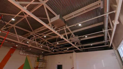 Carcass with Lamps Pattern on Wall and Materials in Gym