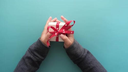 Top View of Child Hand Hold Homemade Gift Box
