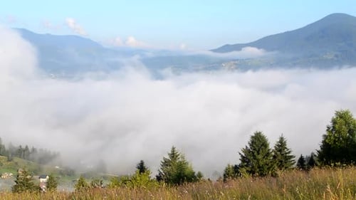 Mountains and Valley Covered in Thick Fog