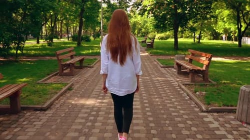 Unrecognizable Female Going in Park