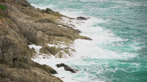 Cliff in The Tropical Ocean, Close Up. Turquoise Sea Water Splashes Against the Shore