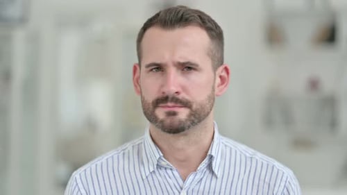 Man with Beard Looking Seriously at Camera