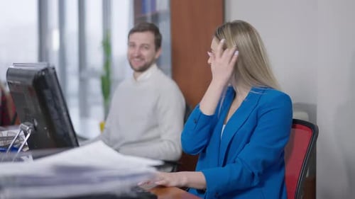Charming Young Slim Woman Talking with Smiling Caucasian Man in Office