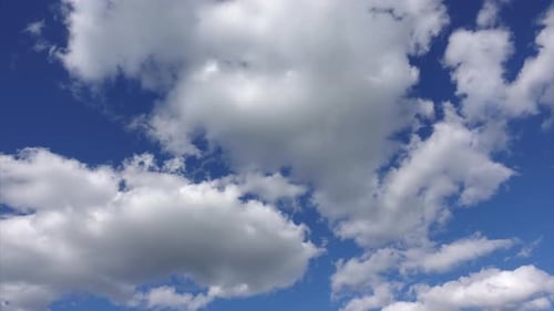 Majestic White Clouds Float Across a Blue Sky