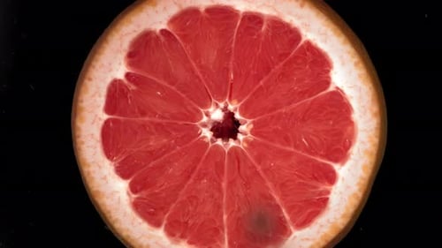 Grapefruit Slice Getting Splashed with Water