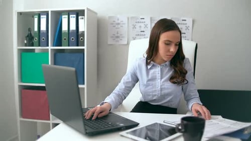 Young Woman Working at Desk With Laptop