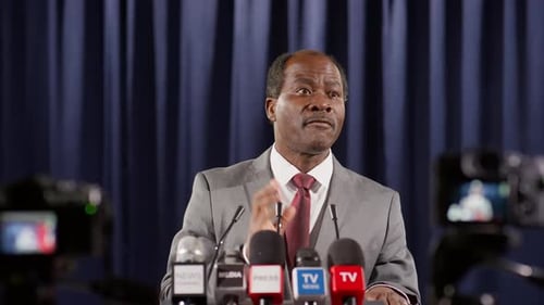 Man Giving Press Conference Speech at Podium