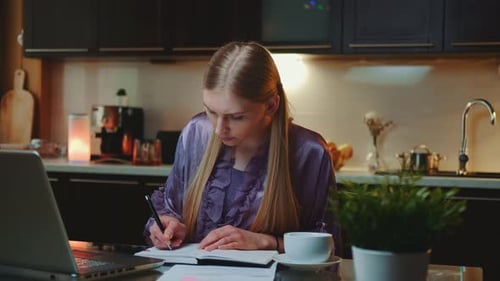 Woman Working From Home in Kitchen with Laptop