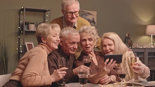 Adults on Video Call with Tablet at Dinner
