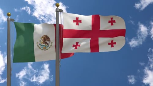 Waving Mexico and Georgia National Flags Against a Blue Sky