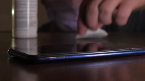Cleaning Smartphone Screen with Pad and Disinfectant