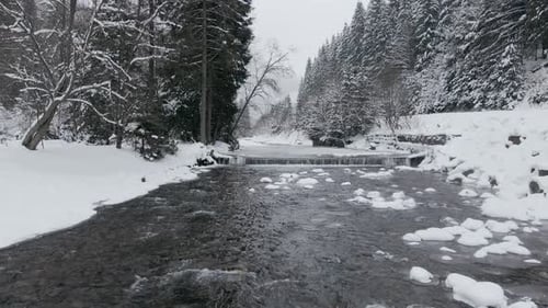 Aerial View Drone Moving Above the Frozen River in Mountains