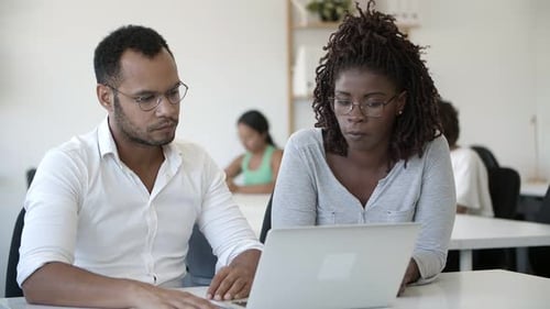 Confident African American Man Talking To Colleague at Office.