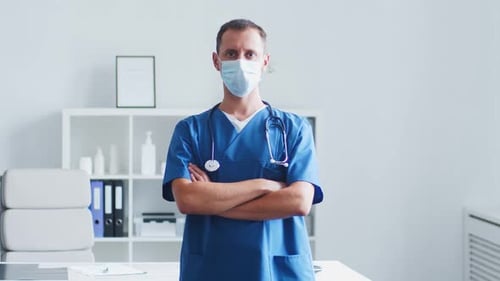 Professional medical doctor working in hospital office using computer technology.