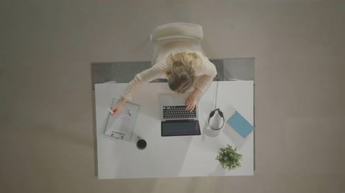 Longhaired woman doing office work