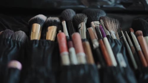 Organizer mit weichen Make-up-Pinseln am Arbeitsplatz von Visagist
