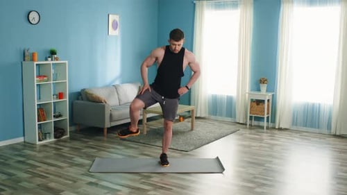 Man Doing Leg Exercises on Yoga Mat at Home