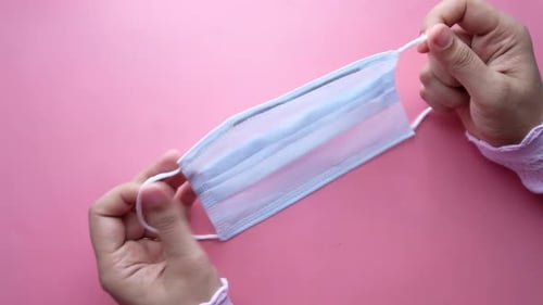Women Hand Holding Homemade Face Mask, Top Down