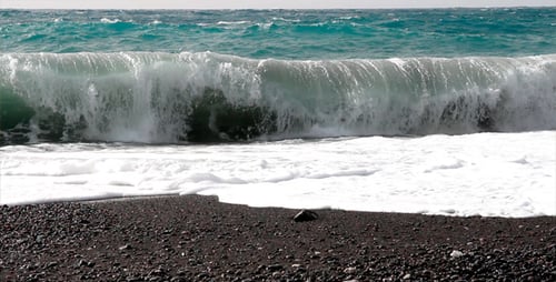 Ocean Waves Crashing on Black Pebble Beach