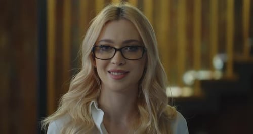 Portrait of Blond Woman with Eyeglasses Working in Open Space Office