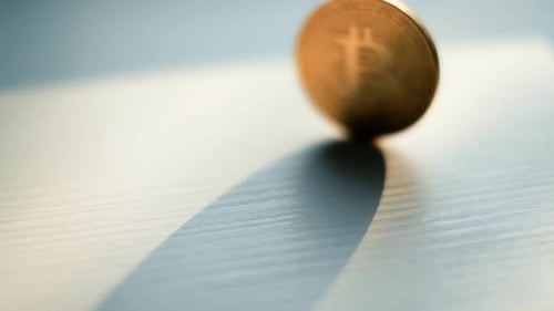 Close Up of Bitcoin Spinning on White Surface