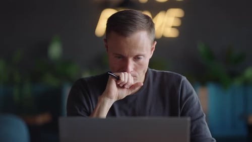 The Man Looks at His Laptop and Thinks