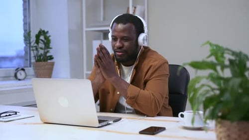 Young Adult on Video Call in Modern Workplace