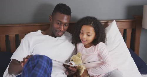 Father Reading a Bedtime Story to his Daughter