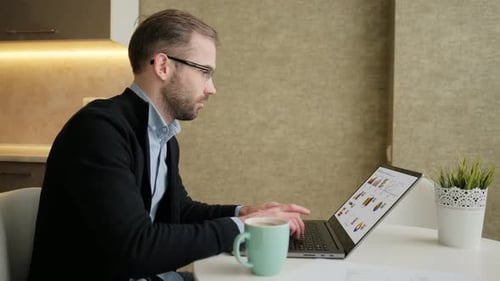 Focused Adult Working on Laptop at Home
