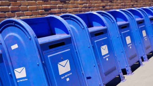 Endless row of blue mailboxes against a brick wall. Seamless looping animation.