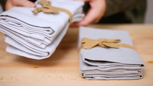 Fabric Napkins Stacked with Twine on Wooden Table