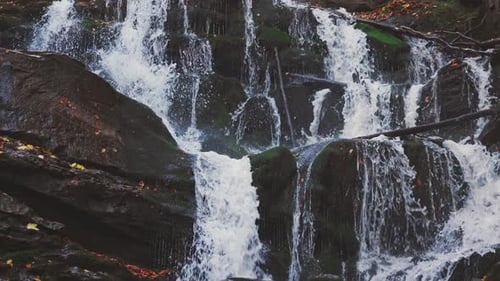 Waterfall Falling Down Mountain Slope in Autumn Forest