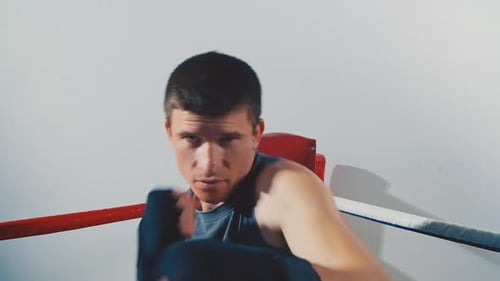 Boxer Throwing Punches in a Boxing Ring