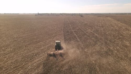 Drone View of Tractor Plowing Farm Field