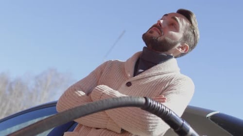 Handsome Man Waiting at Filling Station