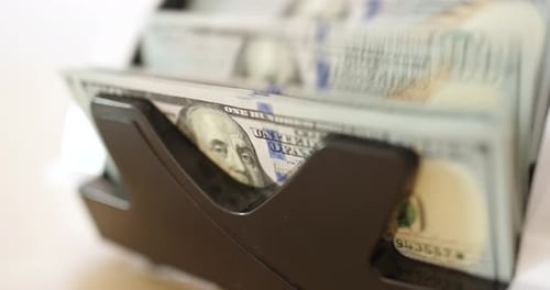 Machine Counts Pile of One Hundred Dollar Bills