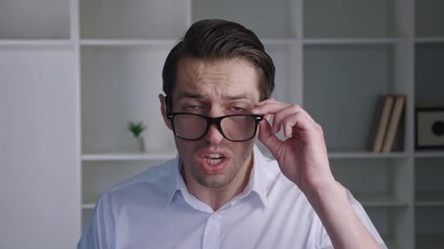 Man takes off glasses, showing facial expressions