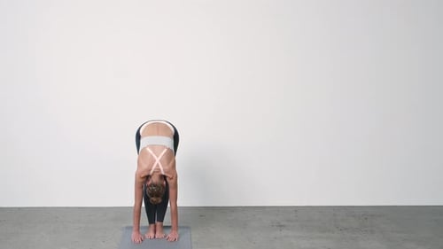 Woman Doing Hamstring Stretch in Fitness Studio