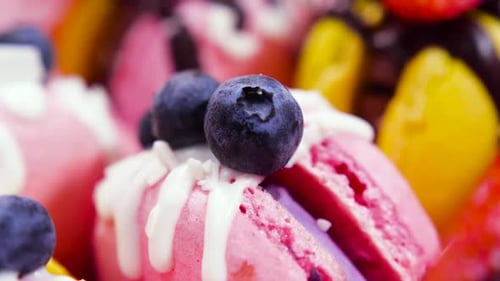 Colorful Macarons with Cream and Blueberries Close Up