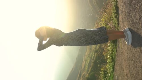 Woman Enjoying Sunny Mountain View at Sunset