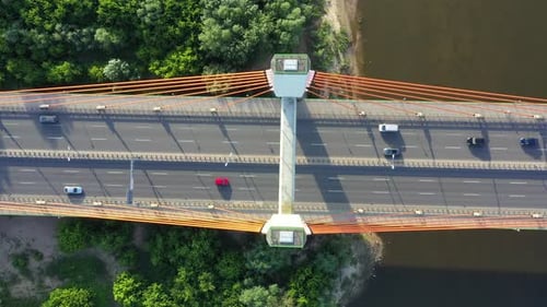 Caring on modern cable stayed bridge over sea in developed city aerial view